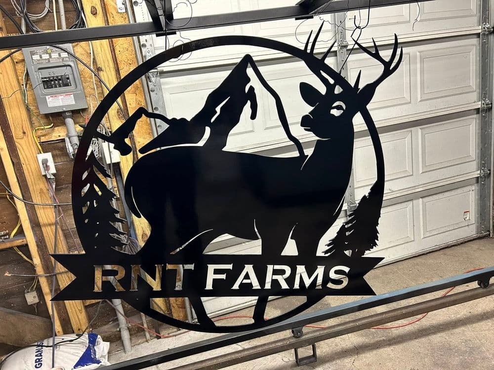 Metal sign of RNT Farms featuring a deer and hunting dog, set in a circular design.