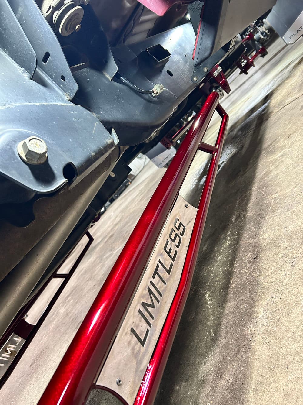 RedLIMITLESS vehicle component showcasing craftsmanship and design in an industrial setting.